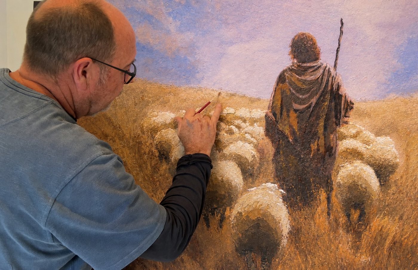 Martin Osner painting the flock of sheep in Eternal Shepherd, his Good Shepherd painting