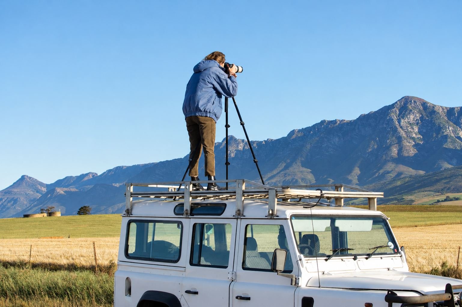 Samantha Lee Osner photographing on location from the roof of the Land Rover