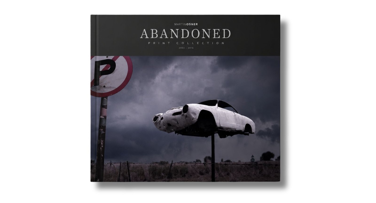 The cover of the Abandoned print collection book by Martin Osner, a car on a pole